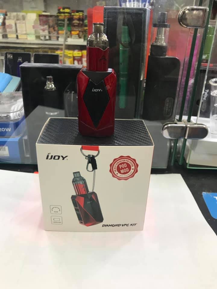 Red iJoy vape device placed on top of its branded packaging box in a retail store display.
